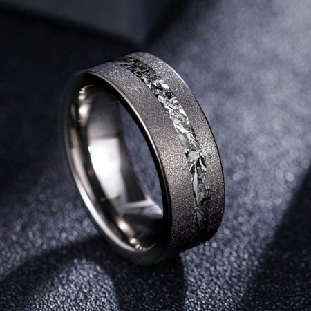 Cosmos ring with meteorite inlay on dark surface