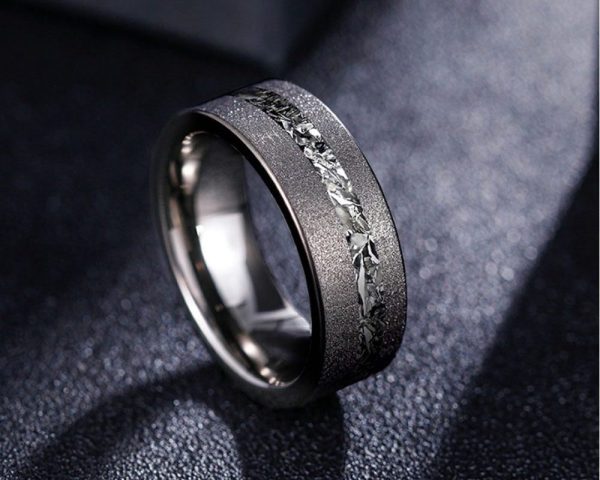 Cosmos ring with meteorite inlay on dark surface