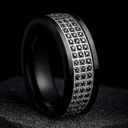 Black ring with embedded diamonds on a dark background